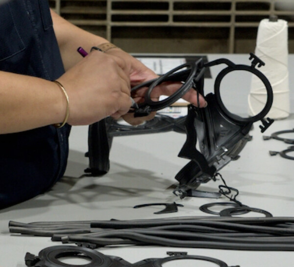 Closeup of a PHE Gasket employee trimming a heat exchanger gasket